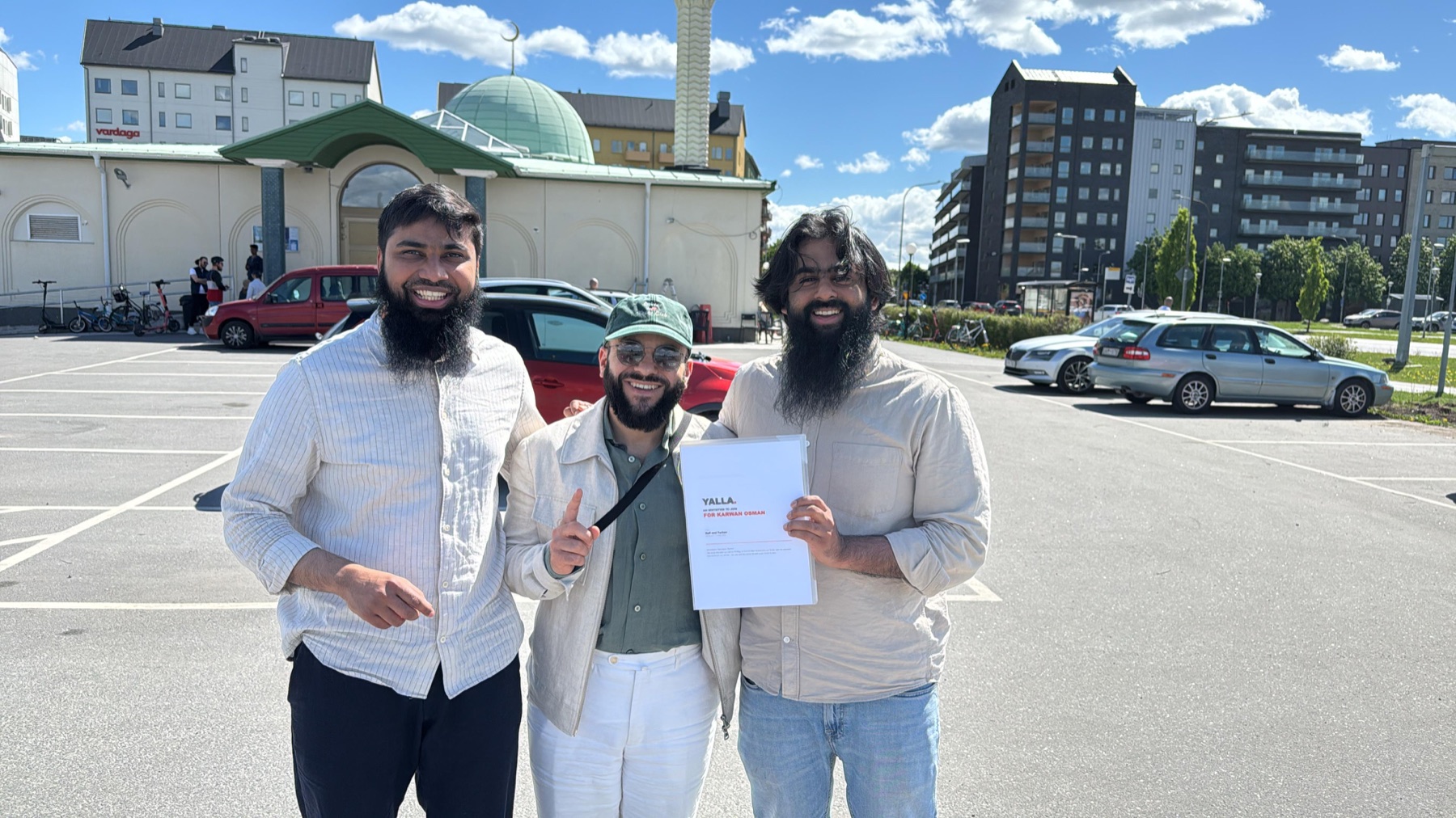 Rafi, Farhan and Karwan outside the masjid in Uppsala, Karwan holding his YALLA invitation